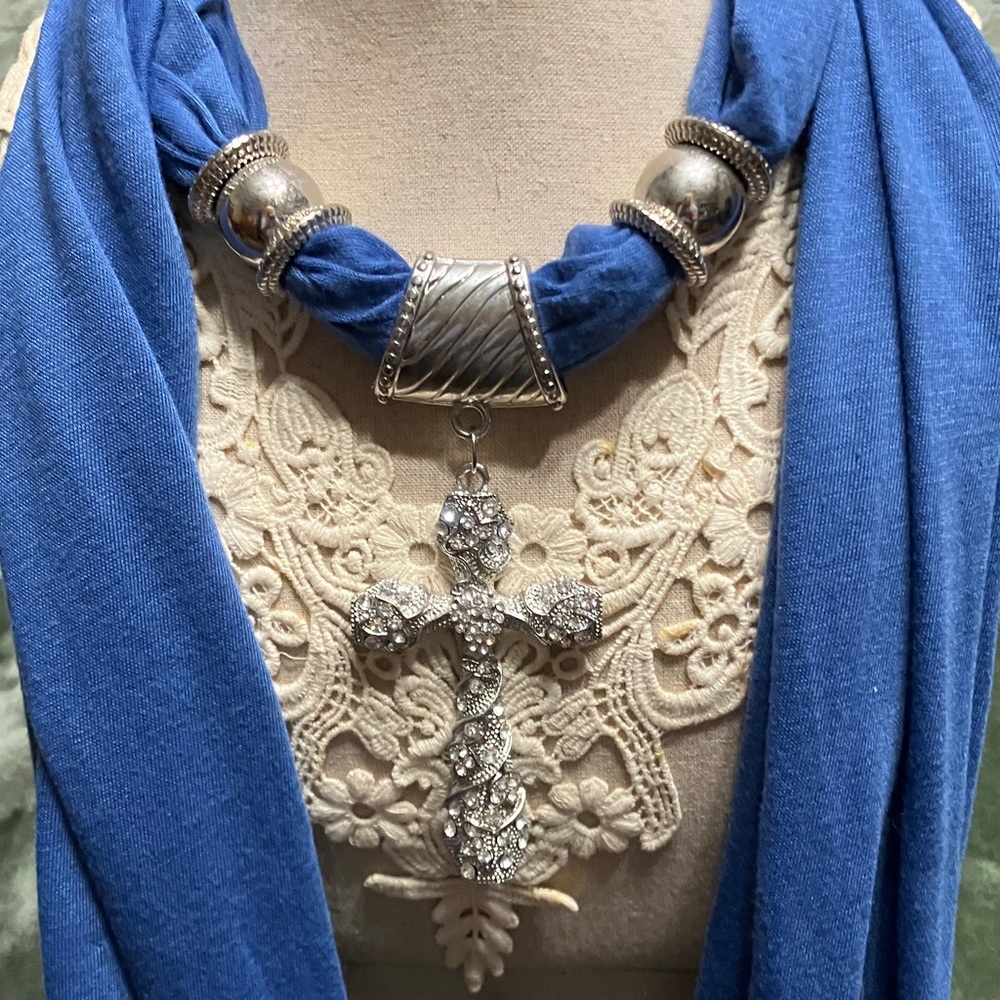 Royal blue scarf necklace with a rhinestone cross, pendant and silver tone beads